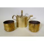 A brass watering can, 30cm high, and a pair of antique brass planters with engraved floral designs
