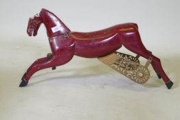 An antique painted wood and metal carousel horse, 75cm long, 36cm high