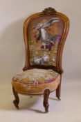 A Victorian walnut nursing chair with carved crest and shaped back, beadwork upholstery, raised on