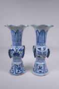 A pair of Chinese Ming style blue and white porcelain gu shaped vases with phoenix and lotus