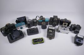A collection of assorted 35mm, 120mm and digital cameras and accessories including Canon ECS 1000F