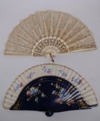 An antique carved wood and lace fan with gilt detail, together with linen and wood fan with hand