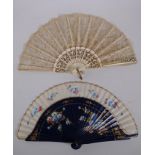 An antique carved wood and lace fan with gilt detail, together with linen and wood fan with hand