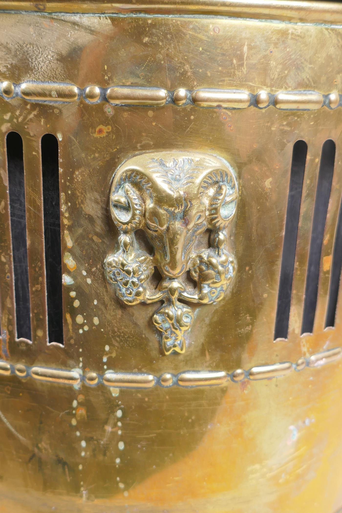 An antique brass coal scuttle with two lion mask loop handles, rams mask decoration and pawed - Image 2 of 4