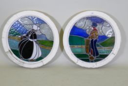 A pair of pine framed round window with stained glass depicting a Dutch boy and girl, 60cm diameter