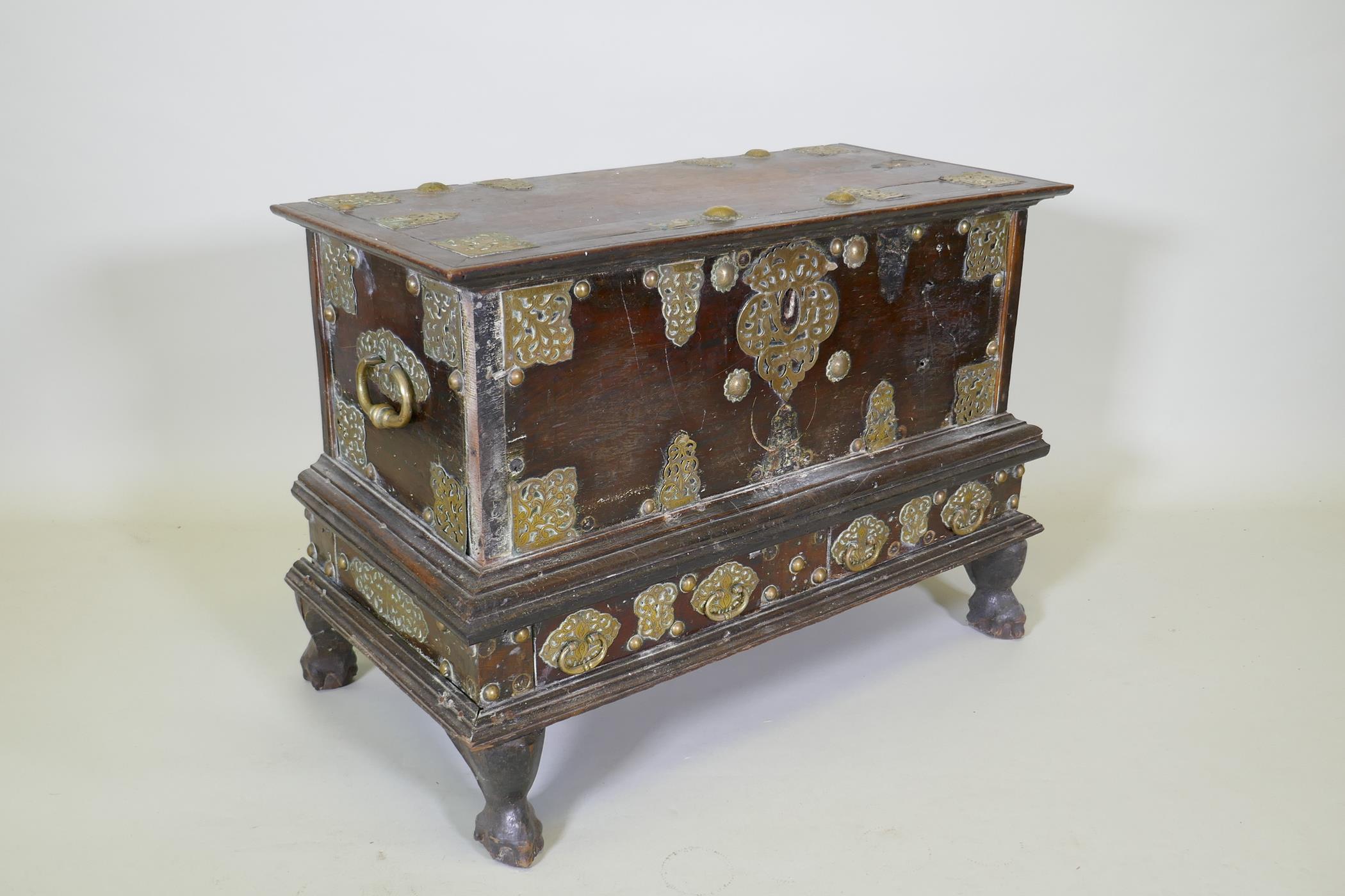 An C18th Dutch colonial teak chest with brass mounts, lift up top and two drawers, raised on claw - Image 3 of 8