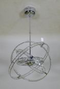 A contemporary chromed metal gimbal ceiling lamp, A/F, 56cm diameter, 82cm long