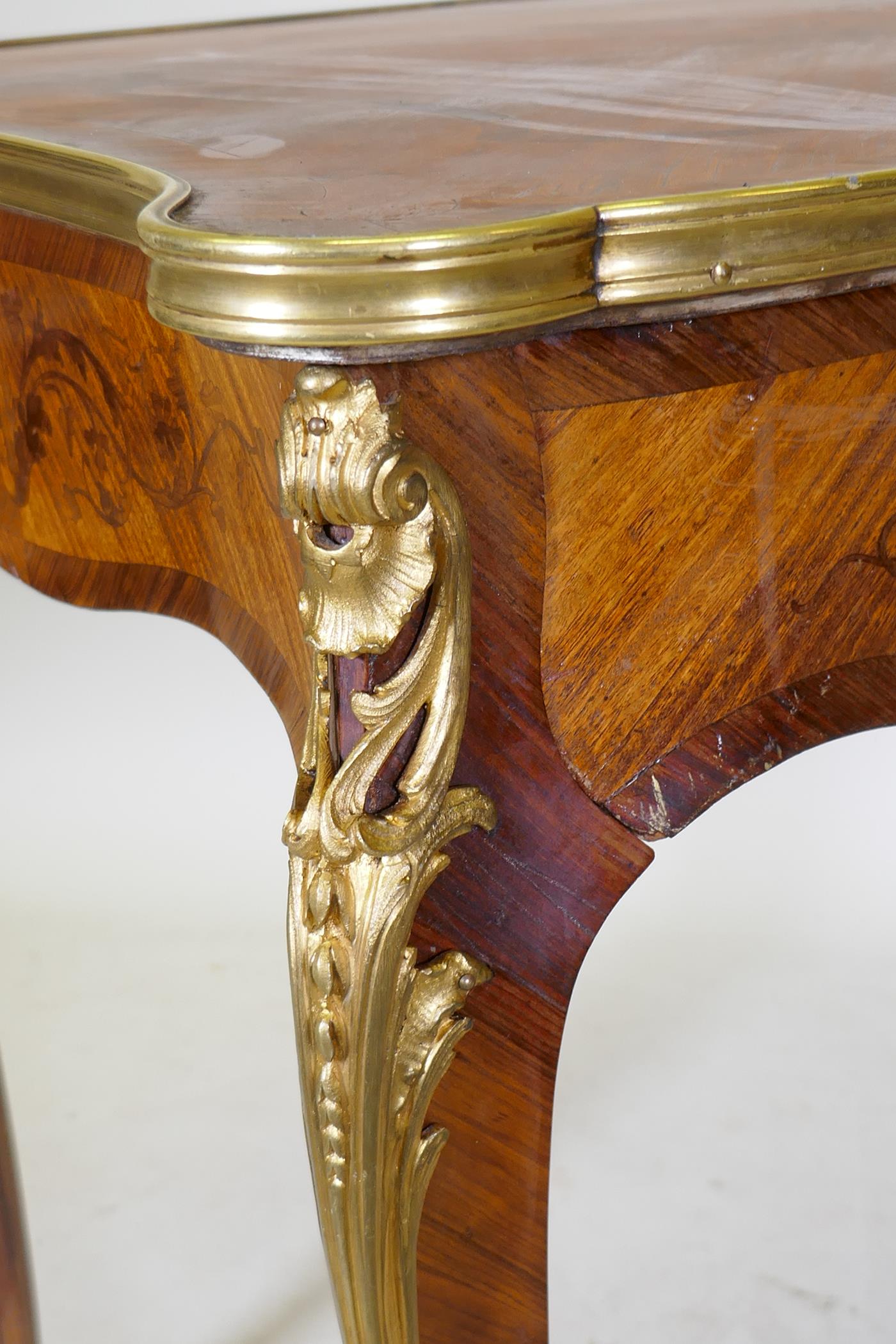 A French marquetry inlaid bureau plat, with shaped top, single drawer and ormolu mounts, bears label - Image 6 of 6