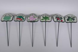 A set of six painted cast iron salad markers, 32cm long