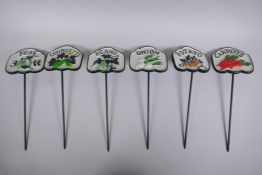 A set of six painted cast iron vegetable markers, 32cm long