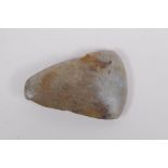 A Neolithic polished hardstone axe head, 8 x 5cm