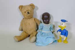 A vintage hump back teddy bear, 47cm long, an early C20th Hugo Wiegand black baby doll with