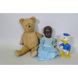 A vintage hump back teddy bear, 47cm long, an early C20th Hugo Wiegand black baby doll with