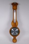 An inlaid mahogany banjo barometer with marquetry decoration and brass finial, 67cm high