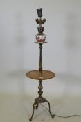A bronze tiered floor lamp with a wooden table and tripod supports, 126cm high