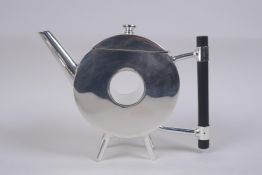 A Christopher Dresser style silver plated teapot of doughnut form, 19cm long