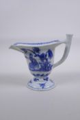 An antique Chinese export ware blue and white porcelain sauce boat decorated with figures and