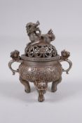 A Chinese white metal censer and cover with two dragon handles, tripod supports and a kylin knop,