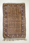 An antique Persian handwoven brown ground prayer mat with geometric directional design, worn, 96 x