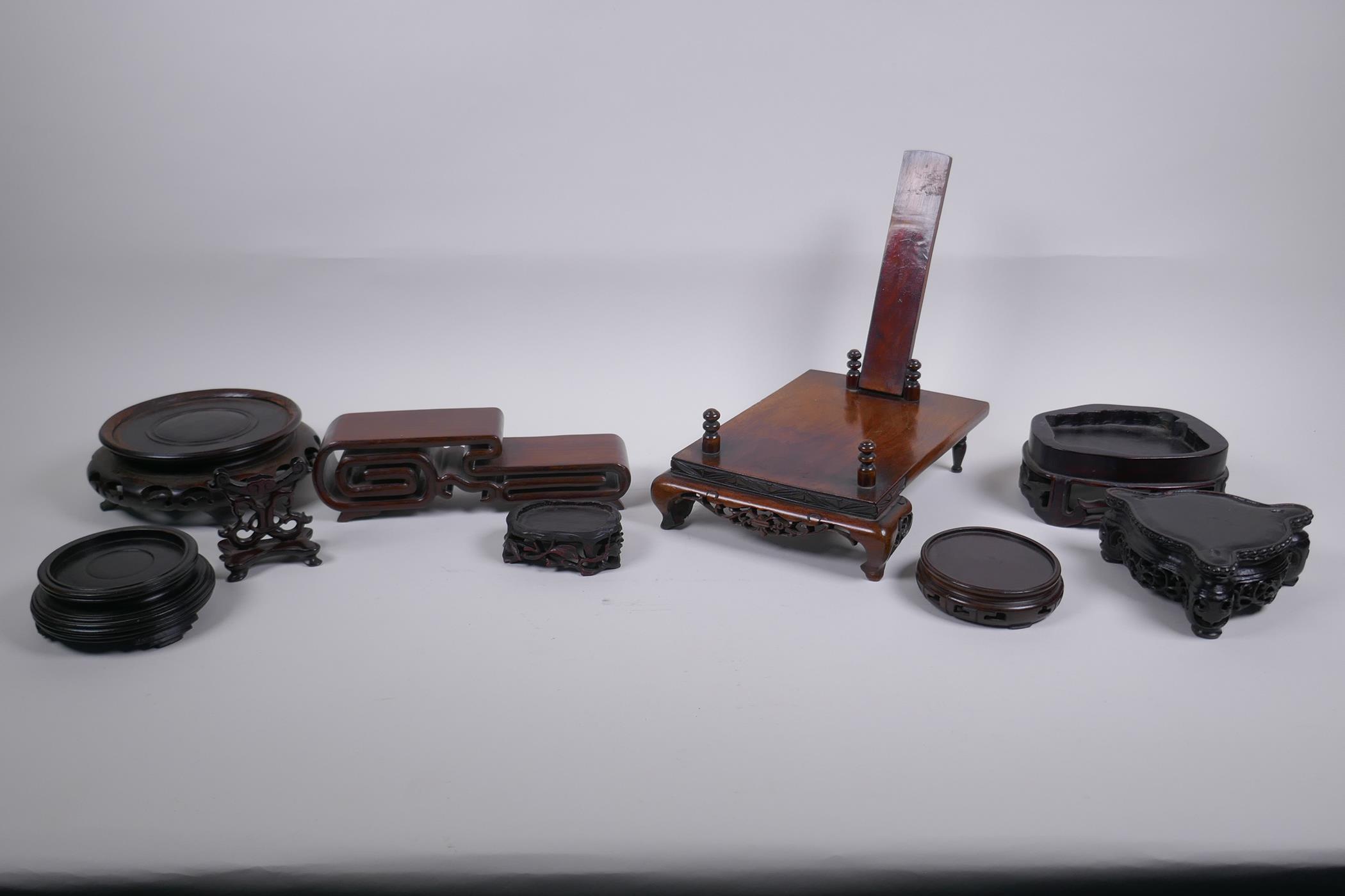 A collection of nine antique Chinese carved and pierced hardwood stands, largest 20 x 16cm