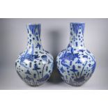 A pair of Chinese blue and white porcelain bottle vases decorated with carp in a lotus pond, 59cm