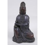 A Chinese bronze figure of Quan Yin seated and holding a ruyi, 23cm high