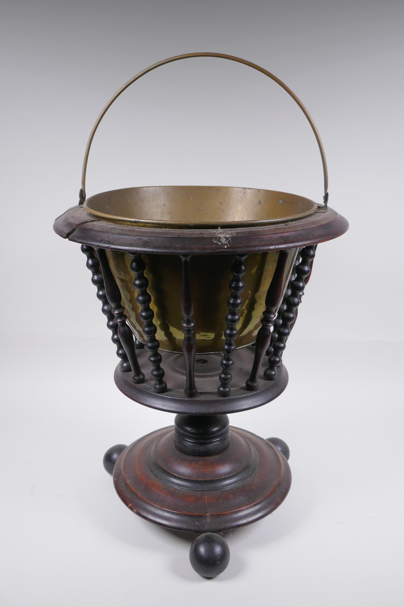 A Dutch wood and brass lined peat bucket with ring turned spindles, AF, 42cm high x 36cm diameter