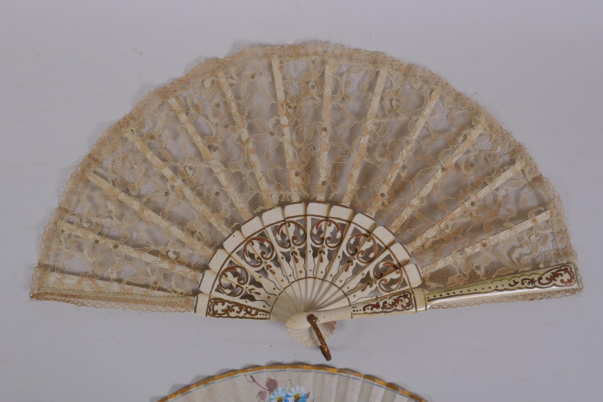 An antique carved wood and lace fan with gilt detail, together with linen and wood fan with hand - Image 2 of 3