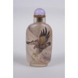 A Chinese reverse decorated glass snuff bottle depicting eagles in flight, 9cm high
