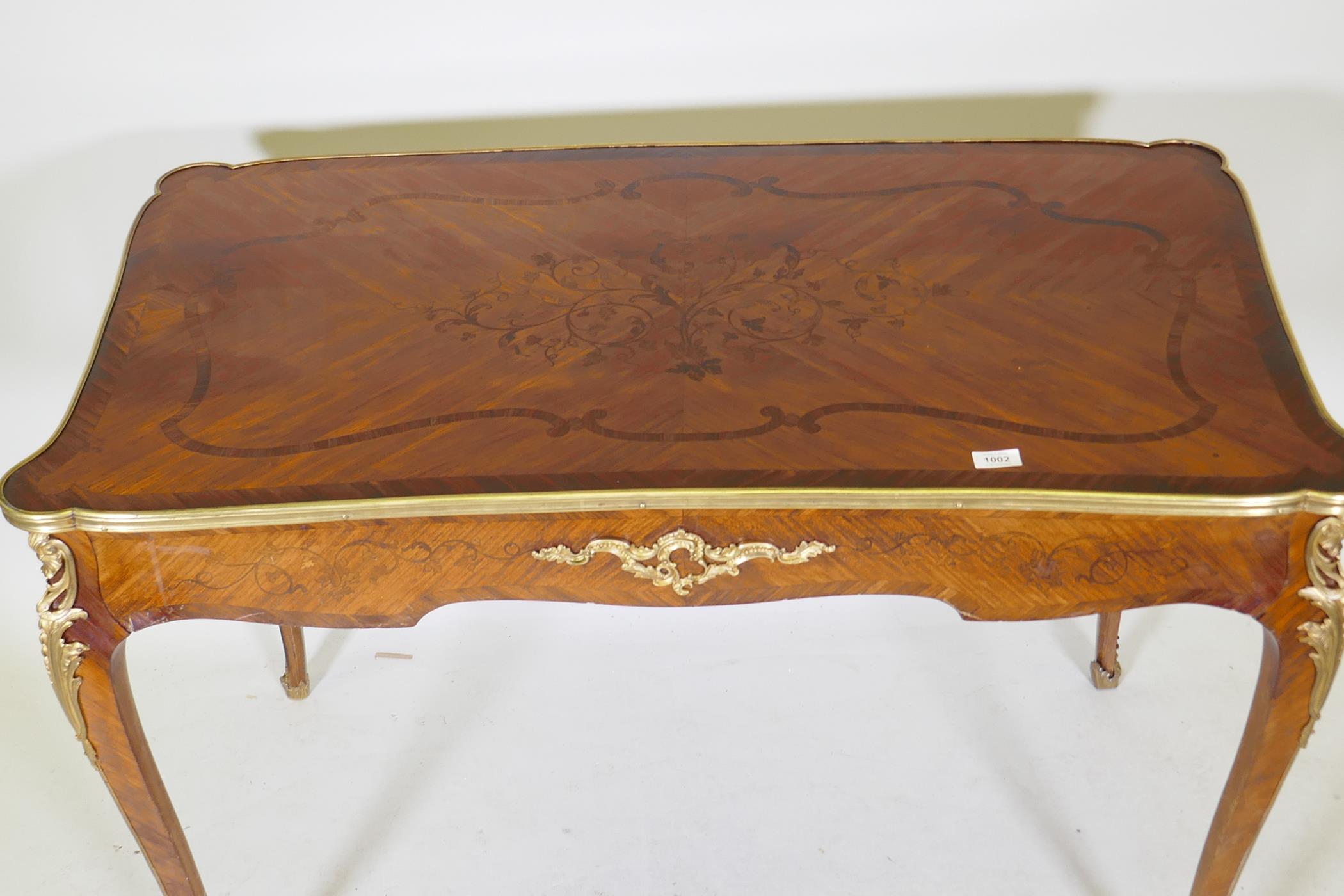 A French marquetry inlaid bureau plat, with shaped top, single drawer and ormolu mounts, bears label - Image 2 of 6