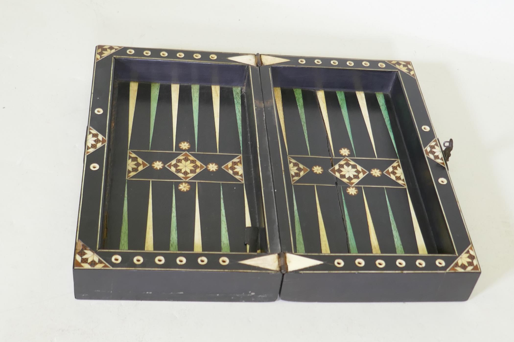 A C19th ebony and ivory and stained bone games box, with chequer board top and backgammon - Image 4 of 4