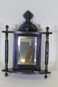 A Victorian Aesthetic style ebonised hanging corner bracket with parcel gilt decoration and mirror