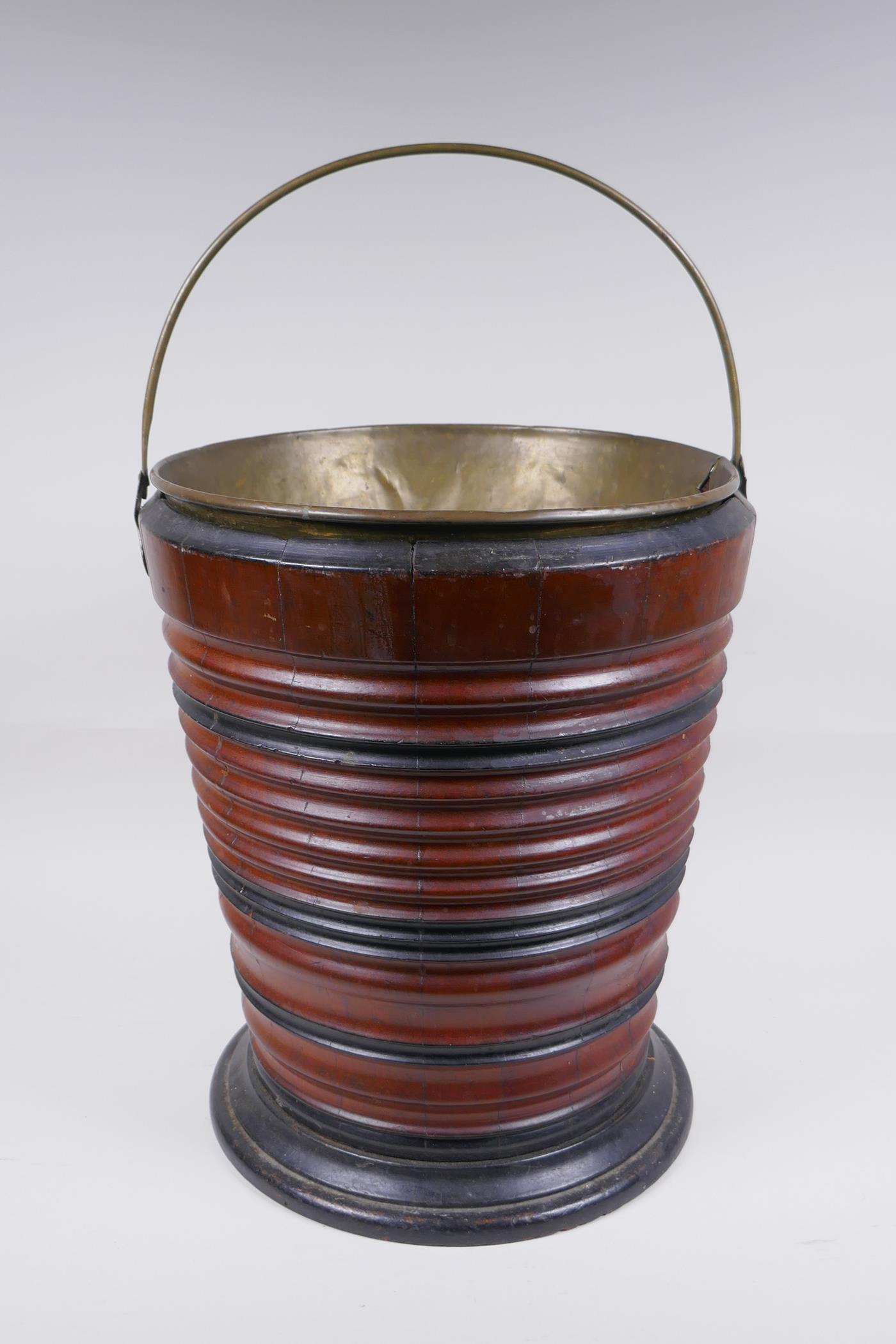 A Dutch coopered fruitwood and brass lined peat bucket, 34cm high, 28cm diameter