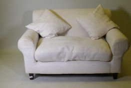 A Habitat two seater sofa with cream coloured linen covers, 140cm wide AF seat stained