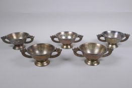 A set of five Chinese silvered metal cups/bowls with two dragon handles, 10 cm diameter