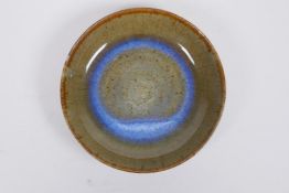 An olive green flambe glazed studio pottery dish by Lin Myerson, 1994, 17cm diameter