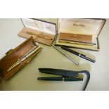 A Cross fountain pen in leather case, Cross ball point in case, an Osmoroid and Parker fountain pen,