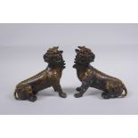 A pair of Chinese filled bronze kylin with gilt highlights, impressed seal mark to base, 14cm