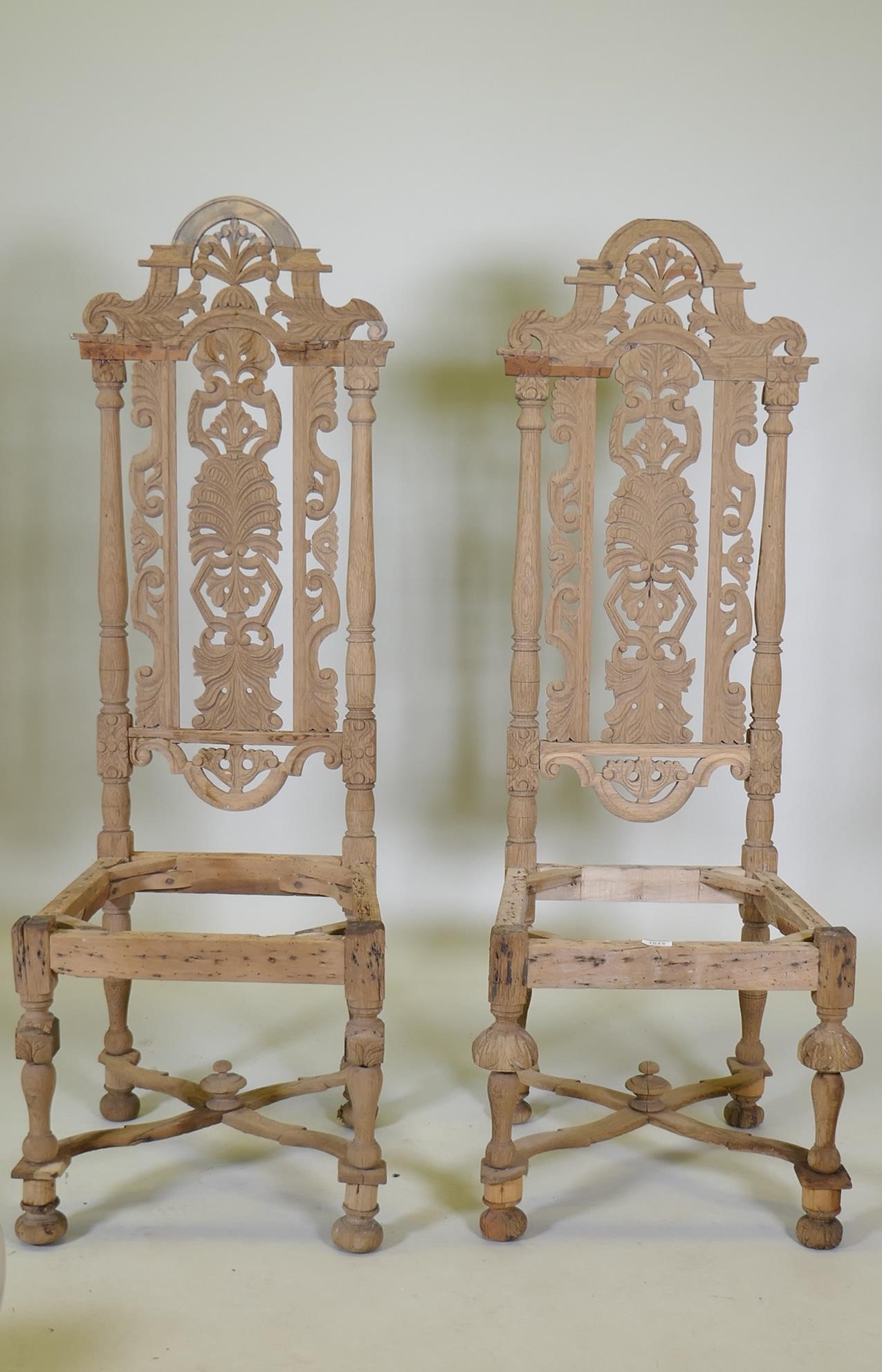 A pair of French C19th oak high back chairs with carved and pierced backs, 128cm high, AF