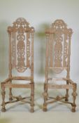 A pair of French C19th oak high back chairs with carved and pierced backs, 128cm high, AF