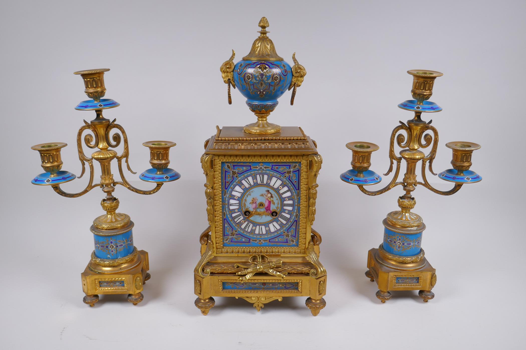 A late C19th/early C20th French ormolu and Sevres style porcelain clock garniture, the hand