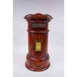 A cylinder fruitwood table post box with brass letter slot and single drawer, 42cm high