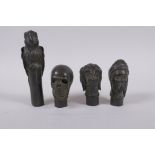 Four bronze walking stick handles in the form of a skull, dog head, head bust and a parrot,