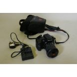 A Sony Digital SLR camera, DSLR A200 with cable charger and case, appears working order