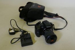 A Sony Digital SLR camera, DSLR A200 with cable charger and case, appears working order
