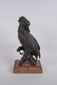A bronze figure of a cockatoo after Bergman, raised on a parcelgilt wood and marble base, 36cm high