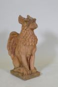 A terracotta garden figure of a griffin, 57cm high