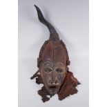 An antique African Igbo tribe carved and painted wood and horn mounted spirit mask, 45cm