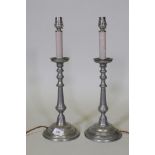 A pair of white metal candlestick table lamps, labelled Casagent Denmark, 43cm high