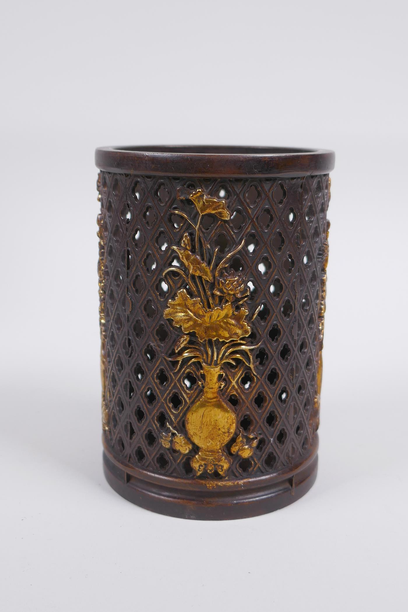 A Chinese pierced bronze brushpot decorated with flowers in vases highlighted with gilt, 12cm high x